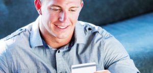 man lookign at his credit card