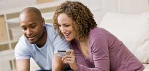 couple with female holding a credit card
