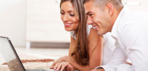 couple lookign at laptop