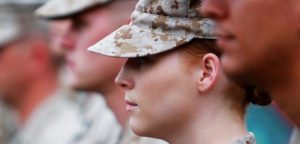 female soldier standing inline with fellow soldiers at attention